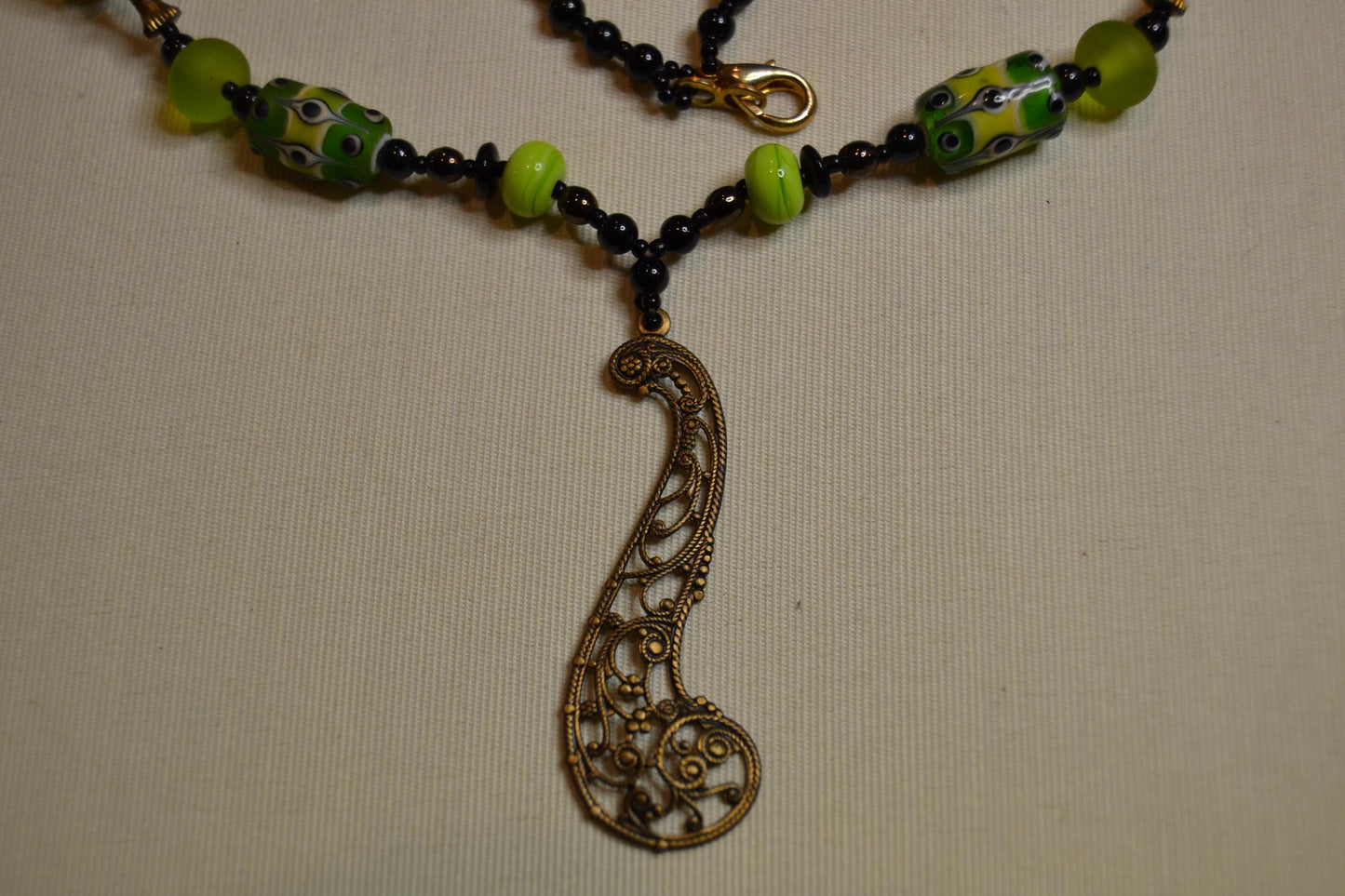 Metal and green lamp work glass beads, vintage feel