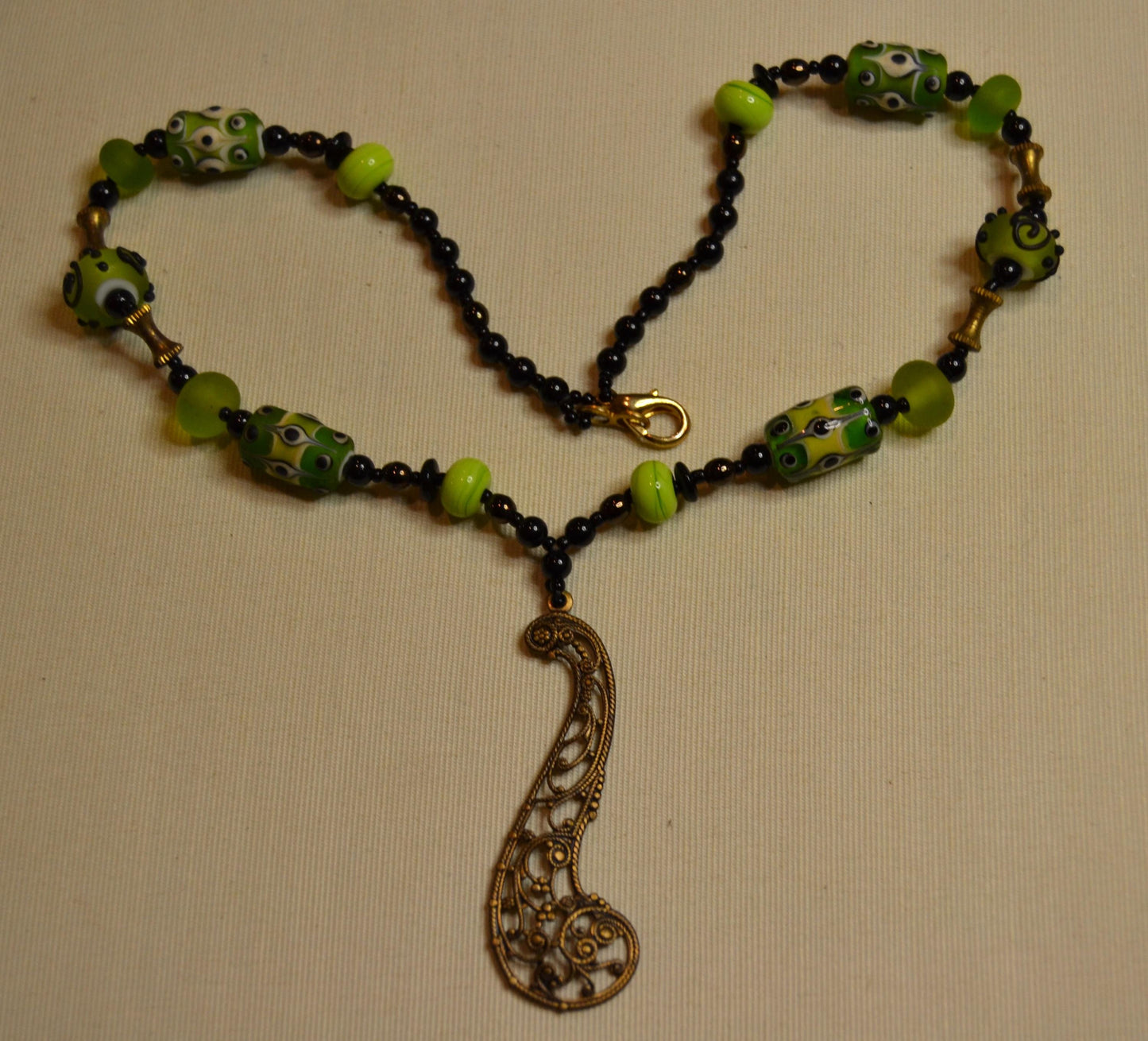 Metal and green lamp work glass beads, vintage feel