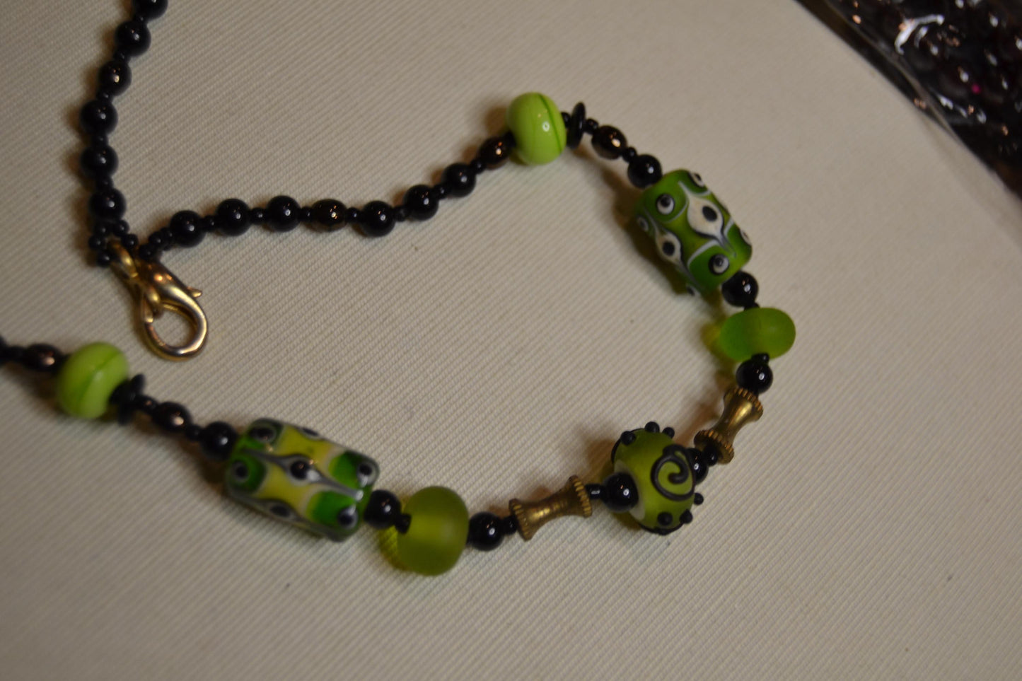 Metal and green lamp work glass beads, vintage feel